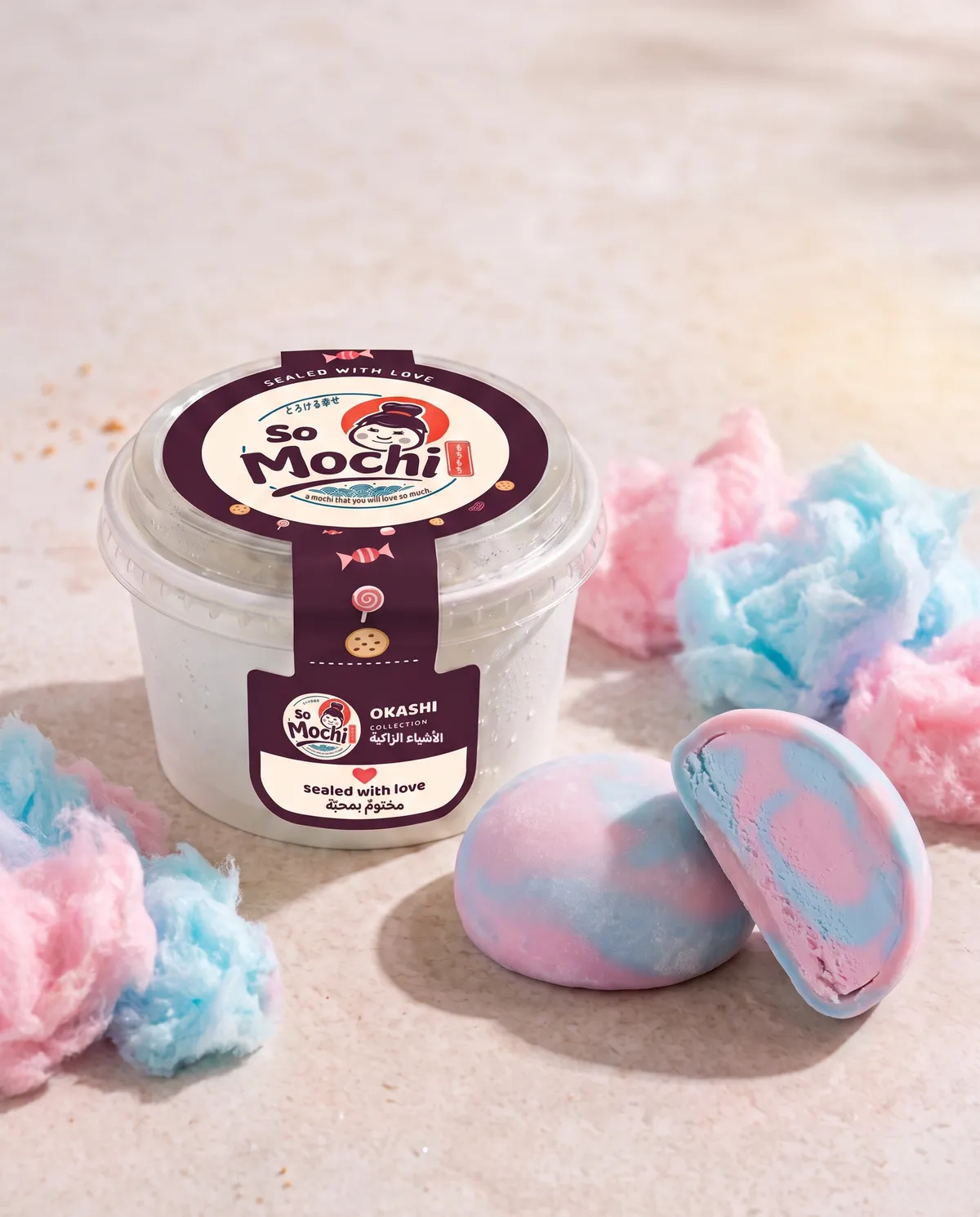 Jumbo Cotton Candy mochi, whole and cut open, beside its sealed So Mochi cup