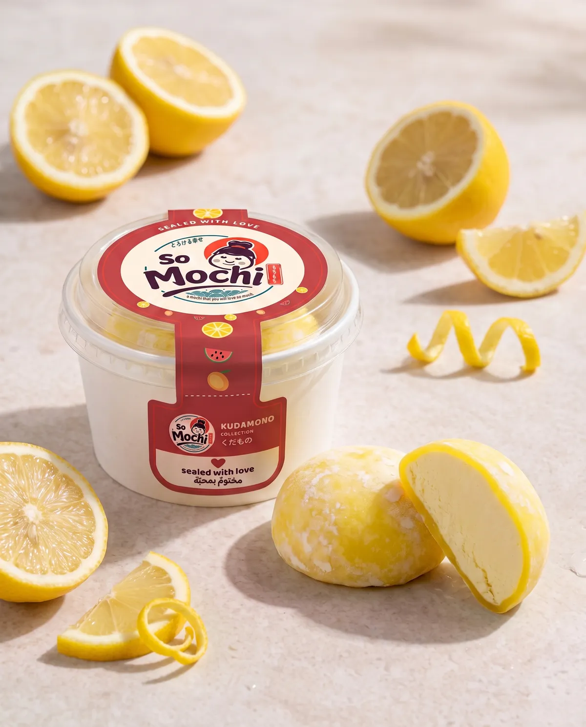 Jumbo Lemon mochi, whole and cut open, beside its sealed So Mochi cup