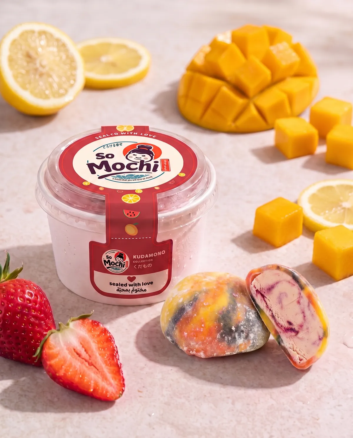 Jumbo Rainbow mochi, whole and cut open, beside its sealed So Mochi cup