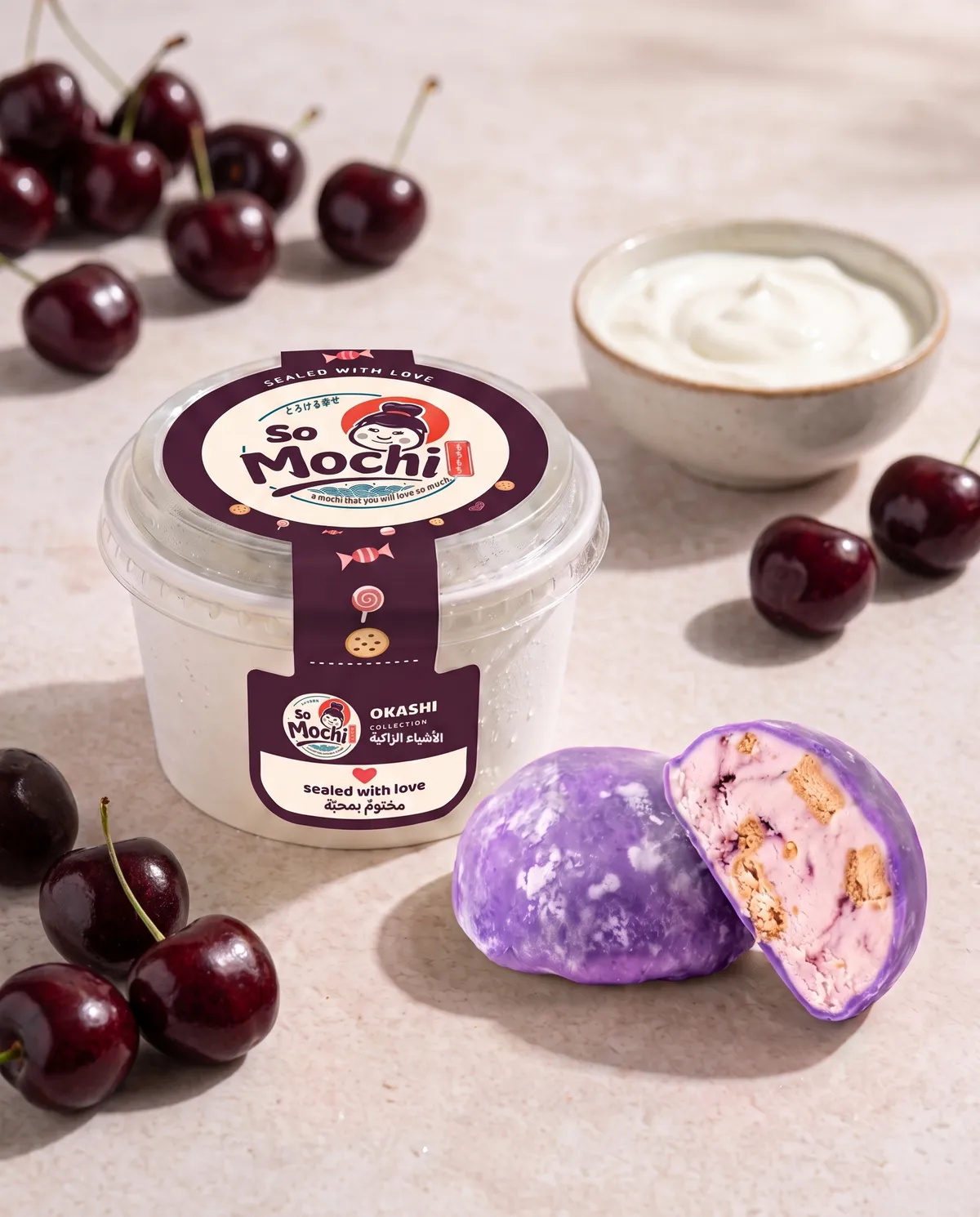 Jumbo Yogurt & Cherry mochi, whole and cut open, beside its sealed So Mochi cup